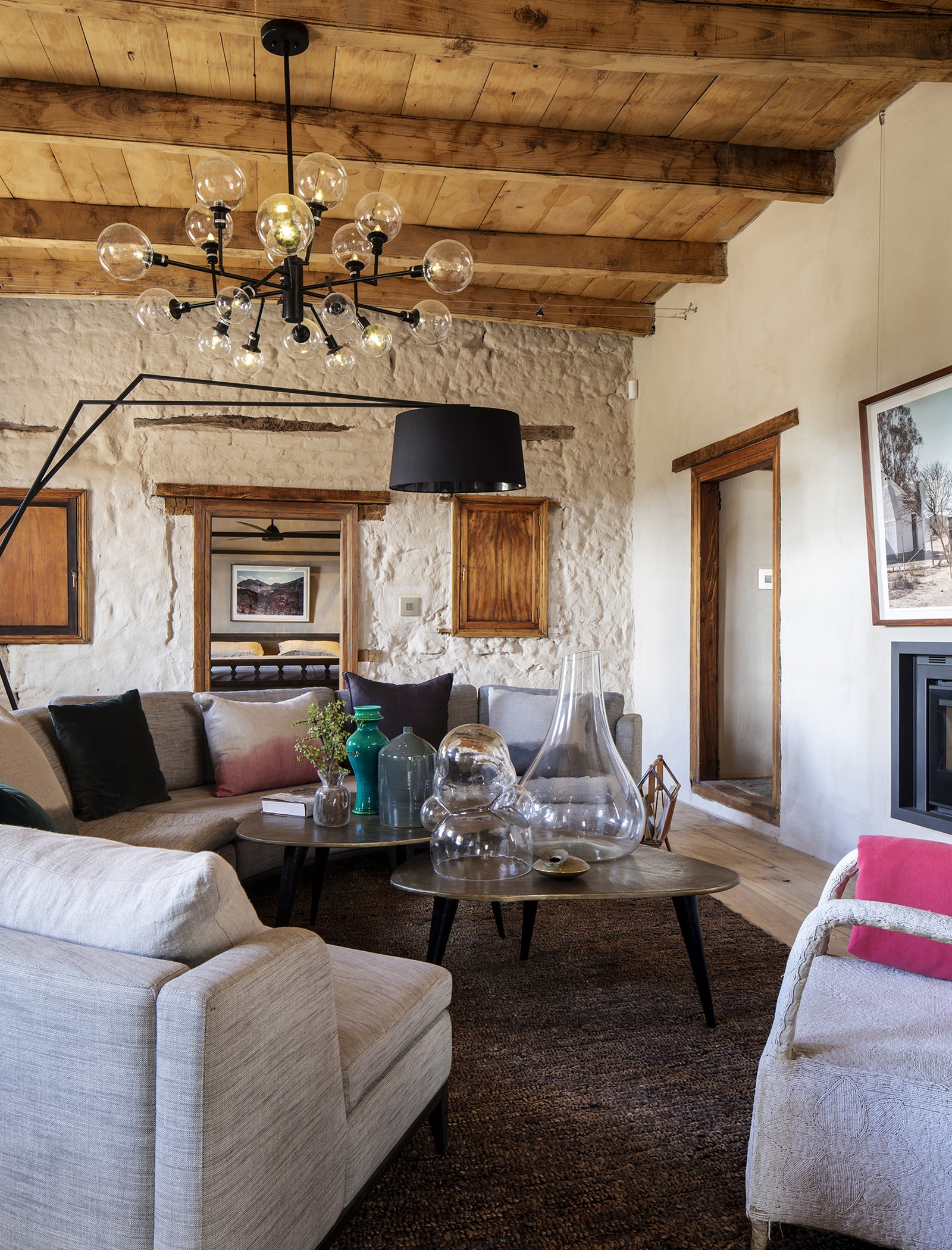 Buffelsdrift — living room, exposed rubble wall and beamed ceiling